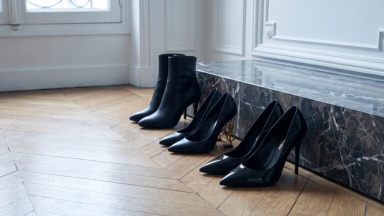 Saint Laurent patent pumps, Opyum heels with gold logo, and black leather ankle boots on parquet flooring